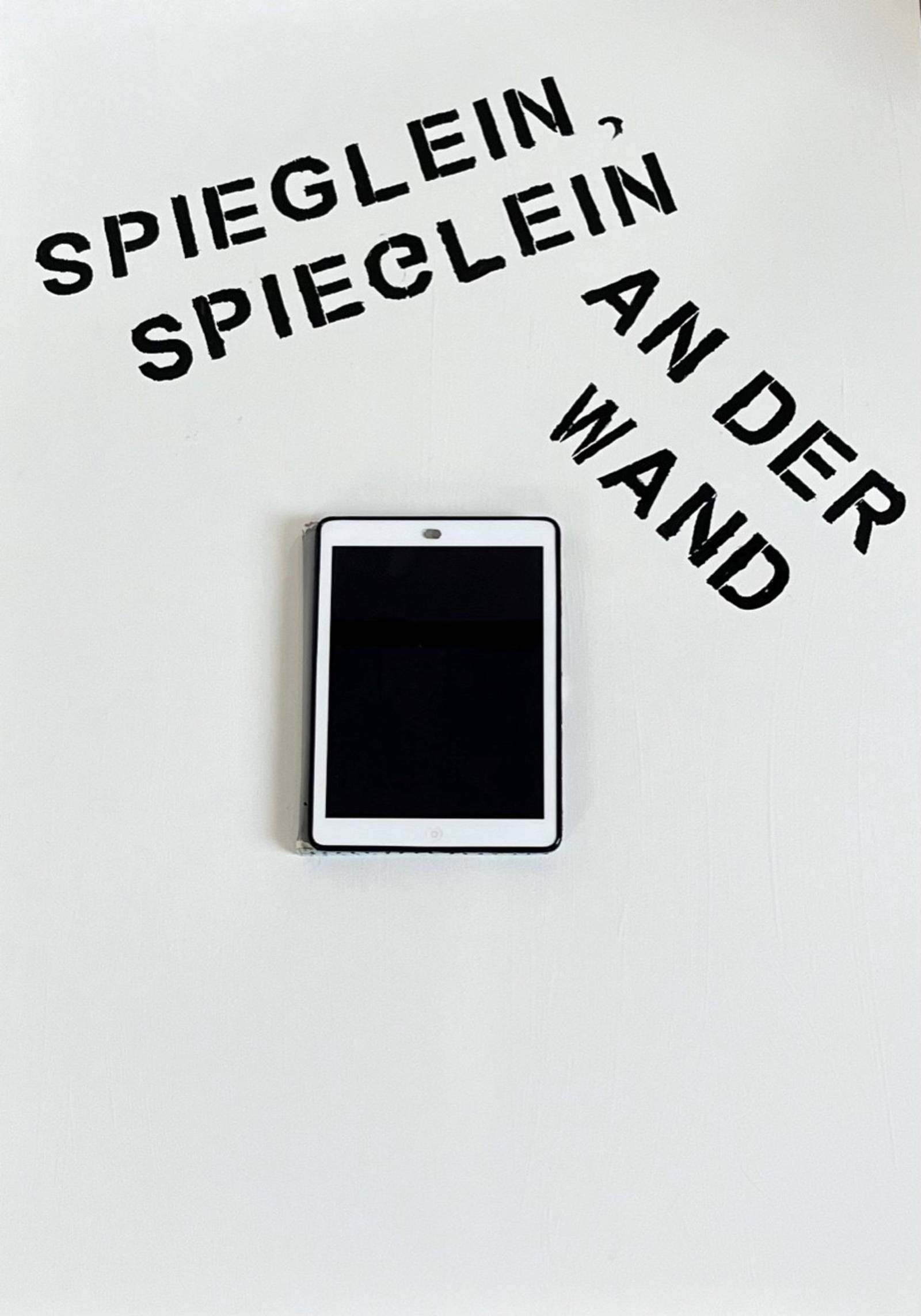 Zu sehen ist ein Foto eines alten iPads. Darüber steht an der Wand geschrieben: „Spieglein, Spieglein an der Wand“